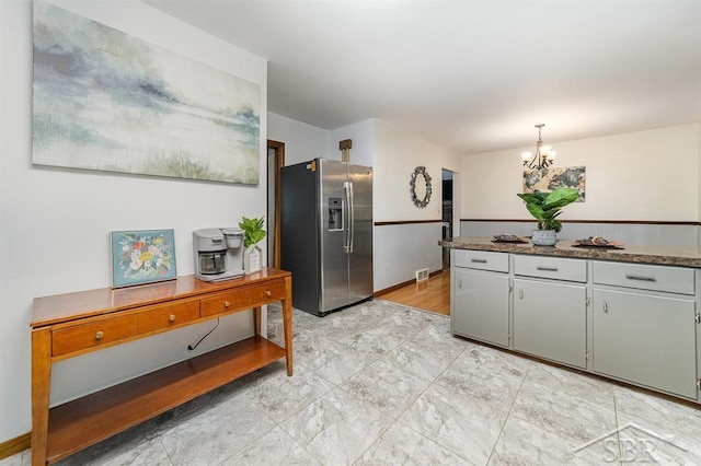 4215 Washington St, Midland, MI 48642 - kitchen with stainless steel refrigerator with ice dispenser, a chandelier, and decorative light fixtures