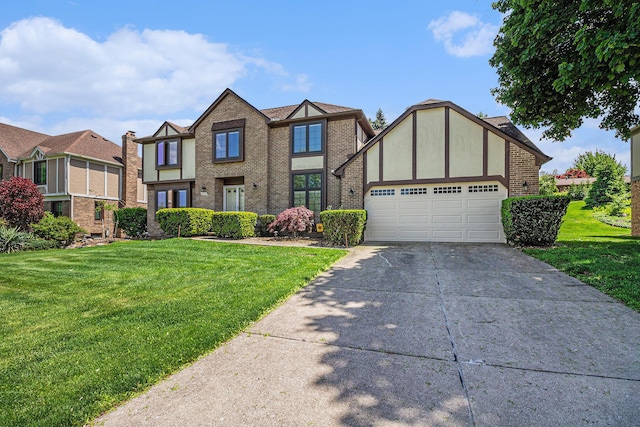 41925 Waterwheel Rd, Northville, MI 48168 - tudor-style house featuring concrete driveway, a front yard, an attached garage, and brick siding