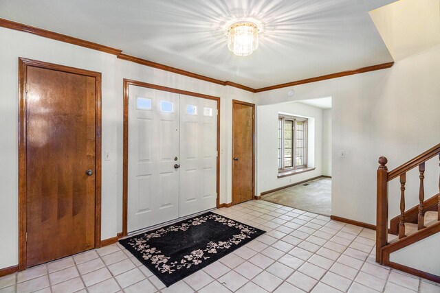 41925 Waterwheel Rd, Northville, MI 48168 - entryway featuring stairway, crown molding, a chandelier, light tile patterned floors, and light carpet