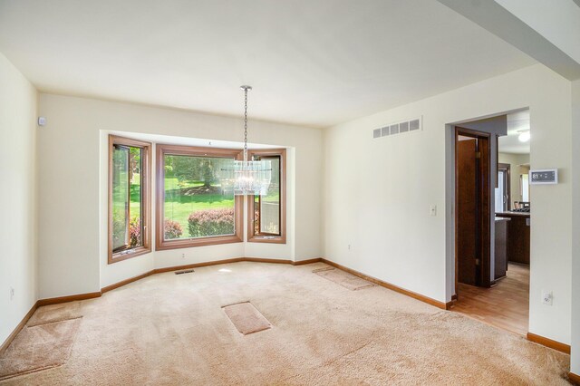 41925 Waterwheel Rd, Northville, MI 48168 - carpeted spare room with baseboards and a chandelier