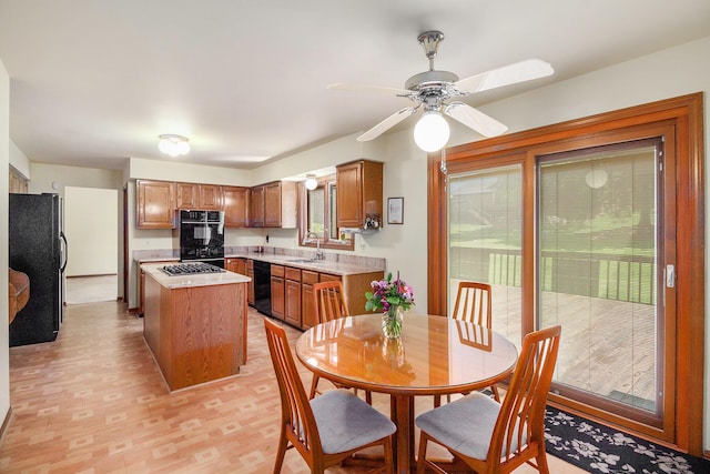 41925 Waterwheel Rd, Northville, MI 48168 - kitchen featuring black appliances, healthy amount of natural light, light countertops, and brown cabinets