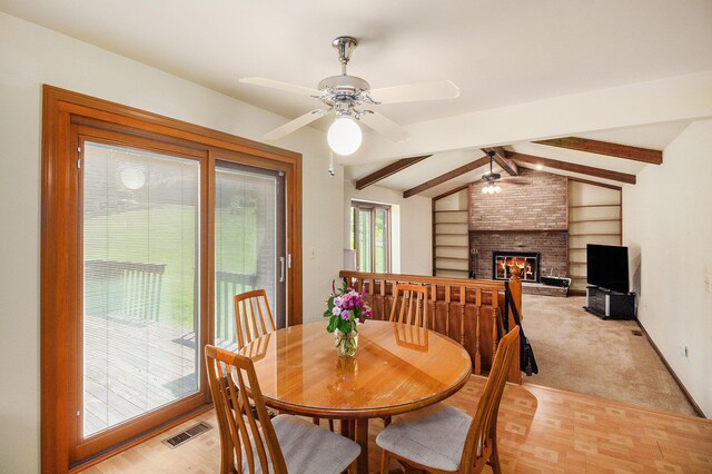 41925 Waterwheel Rd, Northville, MI 48168 - dining space featuring a ceiling fan and a brick fireplace