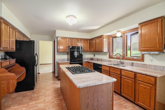41925 Waterwheel Rd, Northville, MI 48168 - kitchen featuring black appliances, a kitchen island, and brown cabinetry