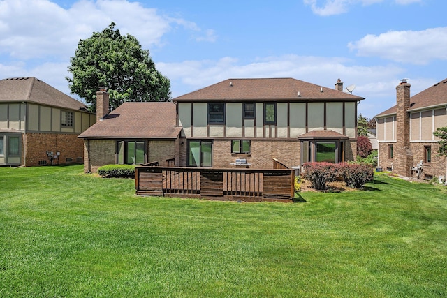 41925 Waterwheel Rd, Northville, MI 48168 - back of property with a yard, a wooden deck, a chimney, and roof with shingles