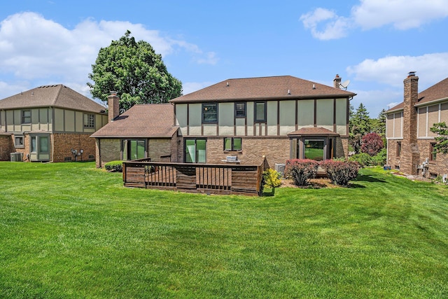 41925 Waterwheel Rd, Northville, MI 48168 - back of house featuring a yard, a deck, a chimney, and brick siding