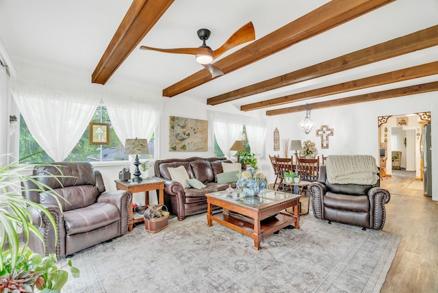 living room with beam ceiling, a chandelier, wood finished floors, and a ceiling fan