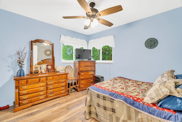 bedroom with wood finished floors and a ceiling fan