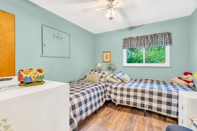 bedroom featuring wood finished floors and ceiling fan