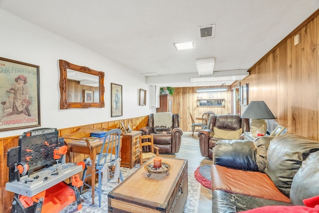 living area featuring wood finished floors and wooden walls