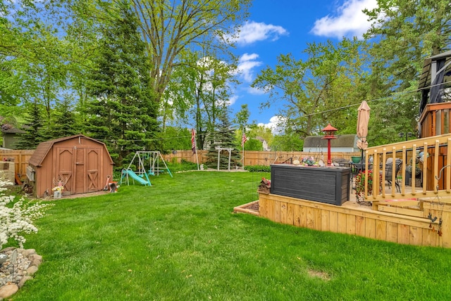 view of yard with a deck and a playground