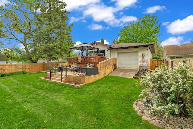 back of house featuring a gazebo, concrete driveway, and a wooden deck