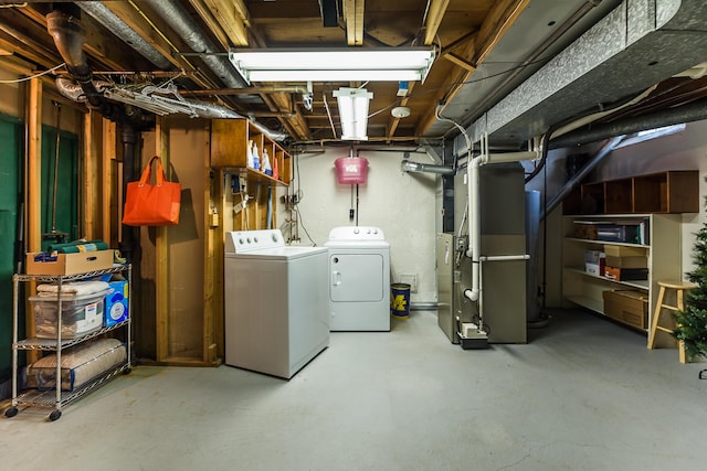 unfinished basement featuring washing machine and dryer and heating unit
