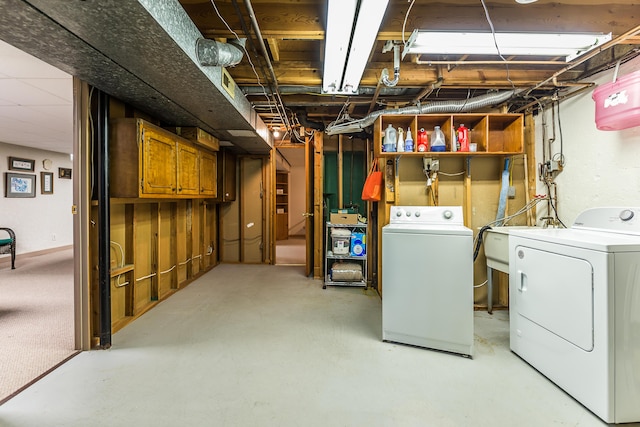 unfinished below grade area with separate washer and dryer and a sink
