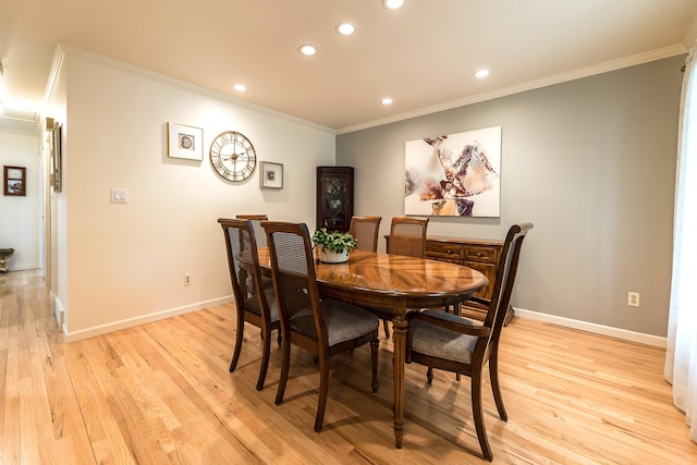 dining room with recessed lighting, ornamental molding, light wood-type flooring, and baseboards