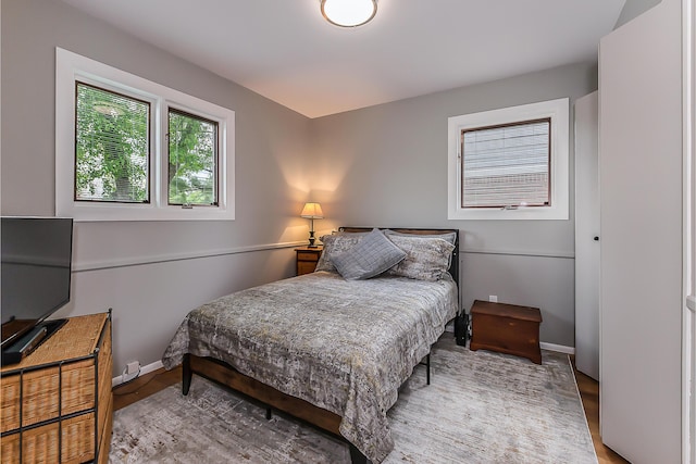 bedroom featuring baseboards and wood finished floors