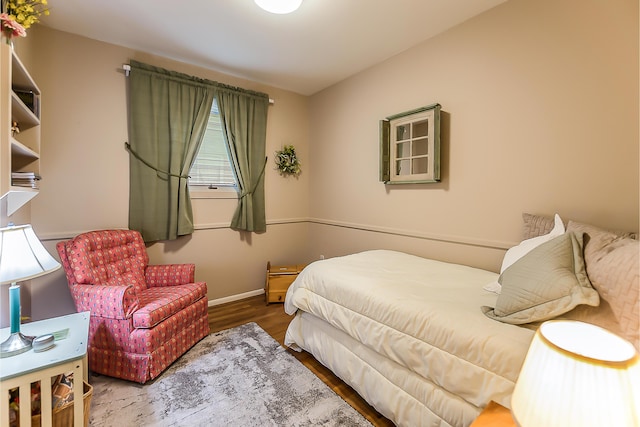 bedroom with wood finished floors and baseboards