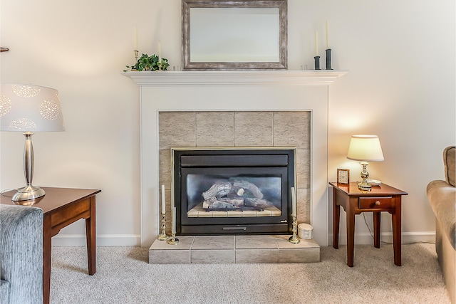 detailed view of carpet floors, baseboards, and a tile fireplace