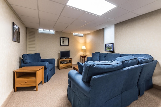 living area with light carpet and a paneled ceiling