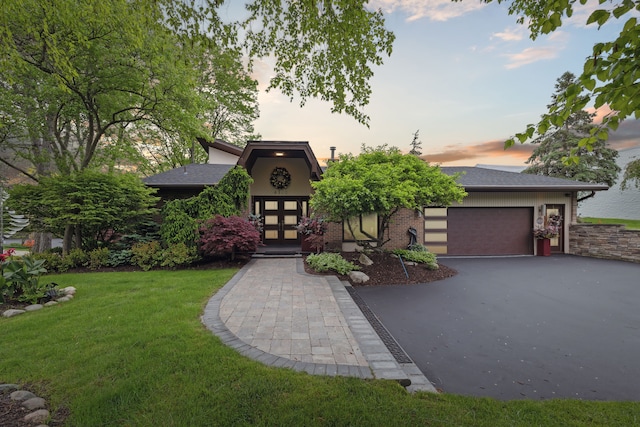 4749 Tara, West Bloomfield, MI 48323 - view of front of property featuring driveway, a front lawn, and an attached garage