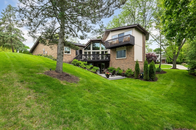 4749 Tara, West Bloomfield, MI 48323 - rear view of property featuring brick siding, a lawn, a balcony, a patio area, and a wooden deck