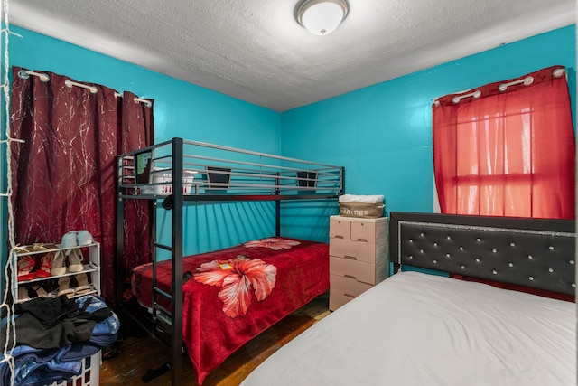 9069 Pierson St, Detroit, MI 48228 - bedroom featuring wood finished floors and a textured ceiling