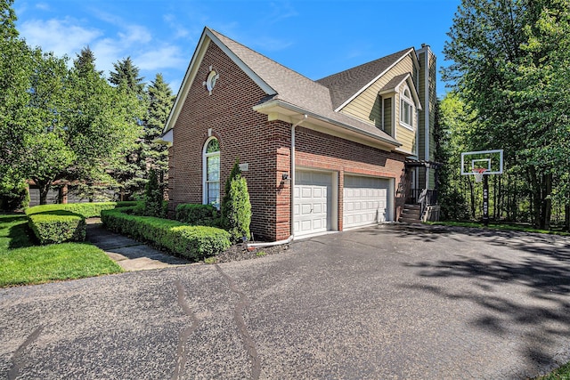 4804 Eagle Springs Ct, Clarkston, MI 48348 - view of side of home featuring brick siding, driveway, a chimney, roof with shingles, and an attached garage