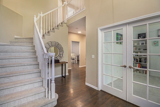 4804 Eagle Springs Ct, Clarkston, MI 48348 - staircase featuring wood finished floors, baseboards, a towering ceiling, and french doors