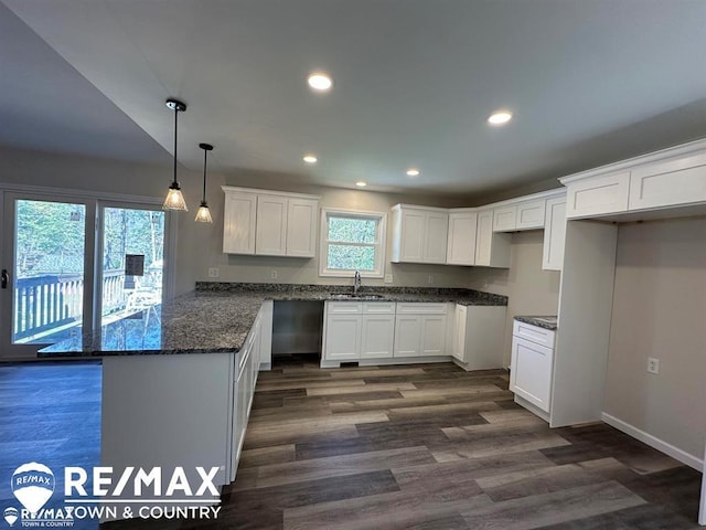 1208 Turrill Rd, Lapeer, MI 48446 - kitchen with a sink, a peninsula, white cabinetry, dark wood-style floors, and dark stone countertops