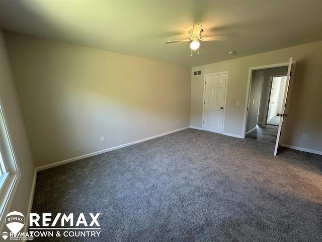 1208 Turrill Rd, Lapeer, MI 48446 - unfurnished bedroom with dark carpet, baseboards, and ceiling fan
