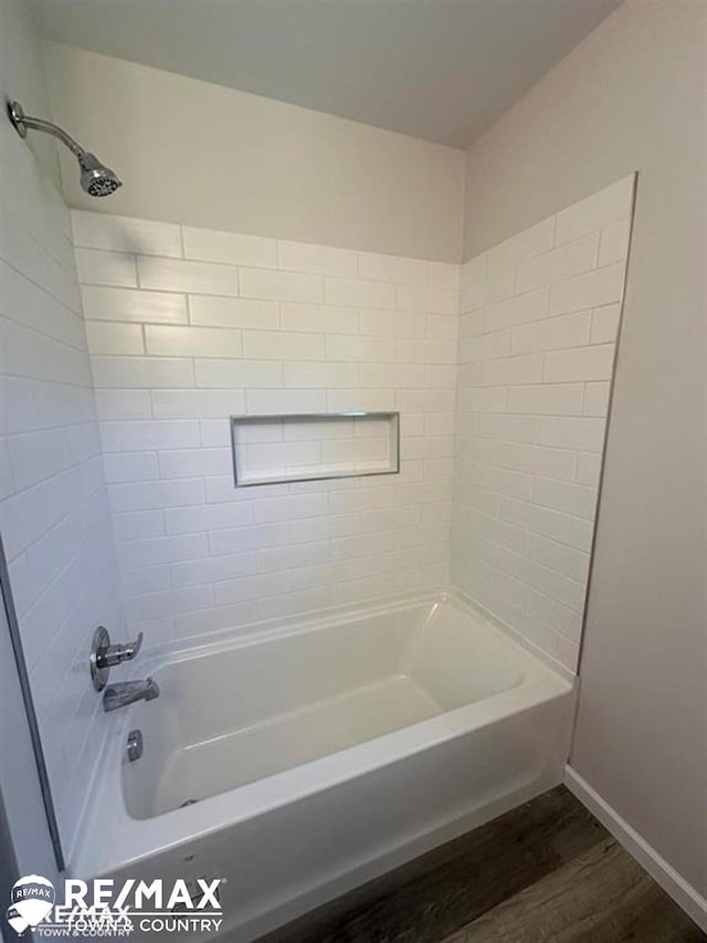 1208 Turrill Rd, Lapeer, MI 48446 - bathroom with wood finished floors, washtub / shower combination, and baseboards