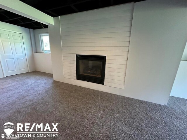 1208 Turrill Rd, Lapeer, MI 48446 - unfurnished living room featuring carpet and a large fireplace