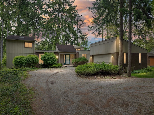 5462 Boyne Highland Trl, Clarkston, MI 48348 - mid-century inspired home with brick siding, a garage, and driveway