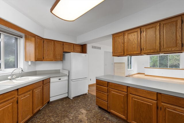5462 Boyne Highland Trl, Clarkston, MI 48348 - kitchen with white appliances, a sink, brown cabinetry, and light countertops