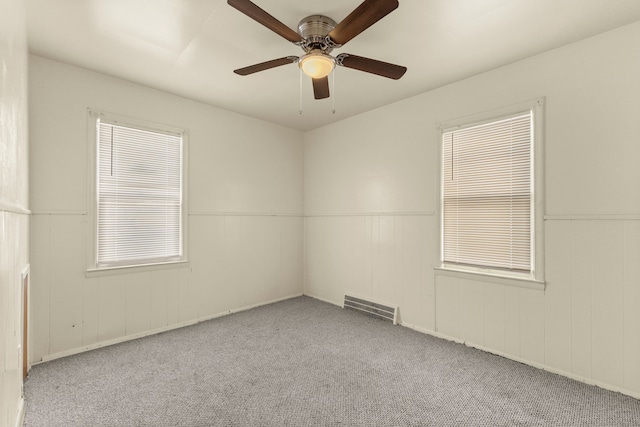 7285 Mansfield St, Detroit, MI 48228 - carpeted empty room with a ceiling fan and wainscoting