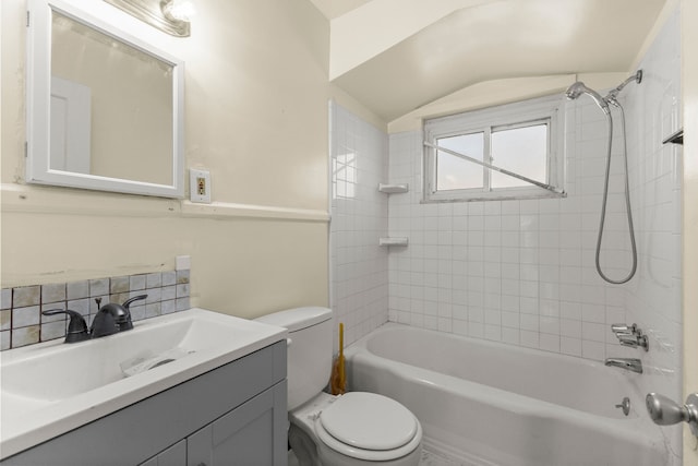 7285 Mansfield St, Detroit, MI 48228 - bathroom featuring vaulted ceiling, toilet, vanity, bathtub / shower combination, and tasteful backsplash