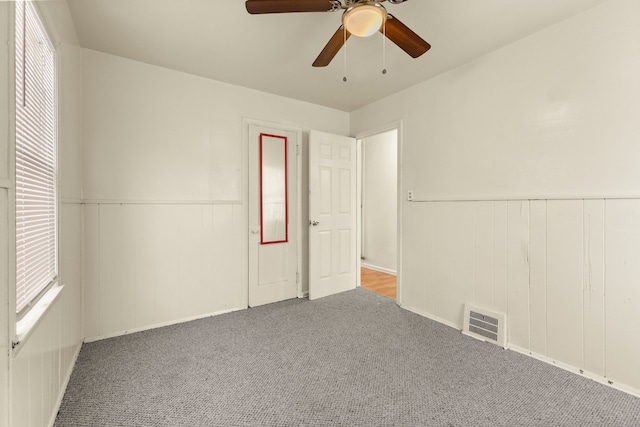 7285 Mansfield St, Detroit, MI 48228 - carpeted empty room featuring wainscoting and a ceiling fan