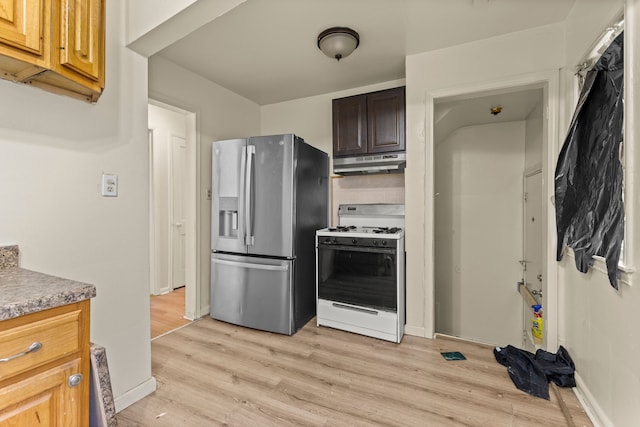 7285 Mansfield St, Detroit, MI 48228 - kitchen featuring stainless steel fridge, white gas range, under cabinet range hood, and light wood-type flooring