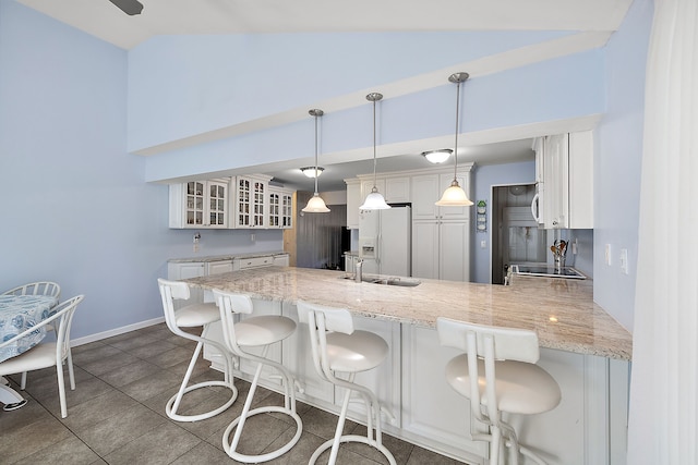 804 E Avon Rd, Rochester Hills, MI 48307 - kitchen featuring white refrigerator with ice dispenser, a peninsula, glass insert cabinets, high vaulted ceiling, and white cabinets