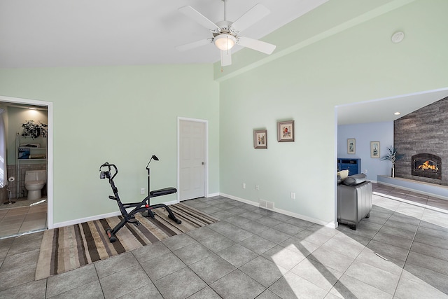 804 E Avon Rd, Rochester Hills, MI 48307 - workout area with tile patterned flooring, high vaulted ceiling, a fireplace, ceiling fan, and baseboards