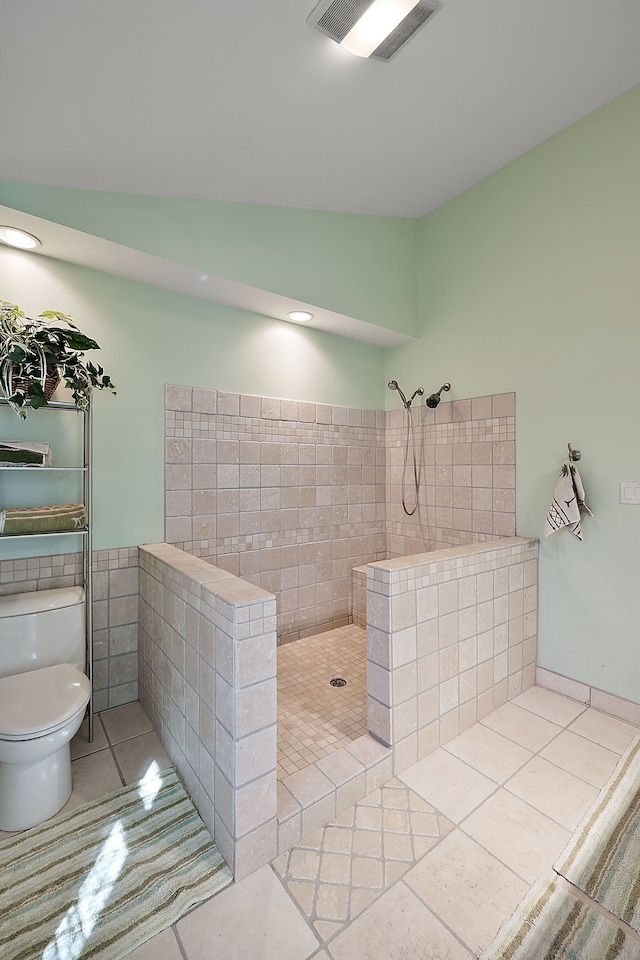 804 E Avon Rd, Rochester Hills, MI 48307 - full bathroom with a tile shower, vaulted ceiling, tile patterned floors, toilet, and tile walls