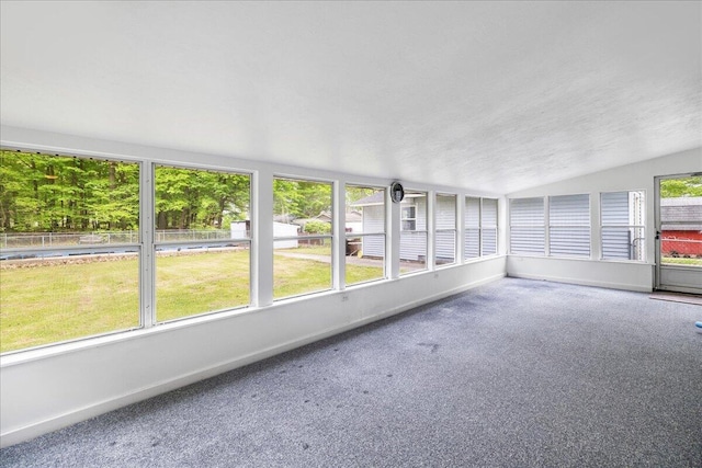45 E Beech St, Fruitport, MI 49415 - unfurnished sunroom with vaulted ceiling, carpet flooring, and baseboards