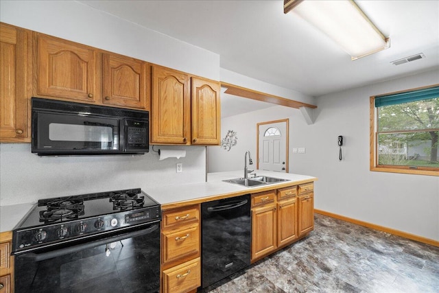 45 E Beech St, Fruitport, MI 49415 - kitchen featuring black appliances, a sink, light countertops, light wood finished floors, and brown cabinetry