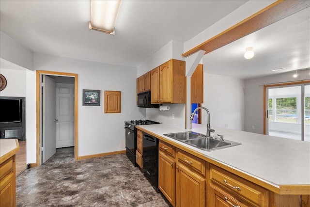 45 E Beech St, Fruitport, MI 49415 - kitchen featuring a sink, black appliances, a peninsula, and light countertops