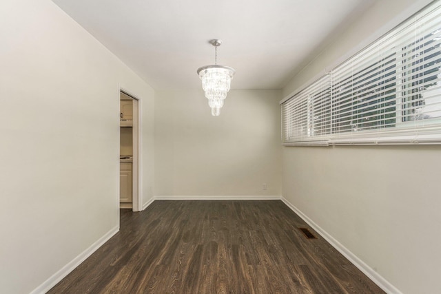 15939 New Hampshire St, Southfield, MI 48075 - unfurnished dining area with dark wood-style flooring, baseboards, and a chandelier