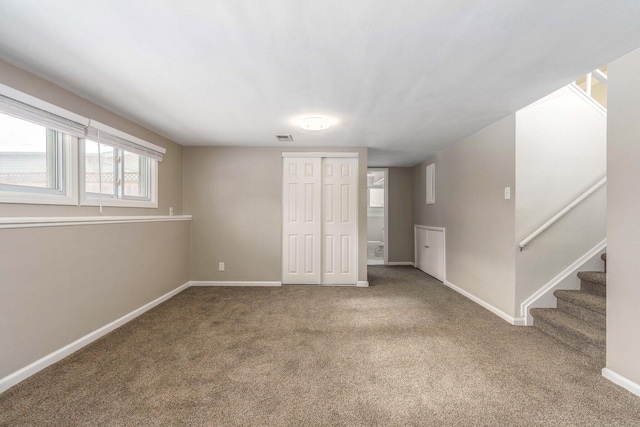 15939 New Hampshire St, Southfield, MI 48075 - unfurnished living room featuring carpet, baseboards, and stairway
