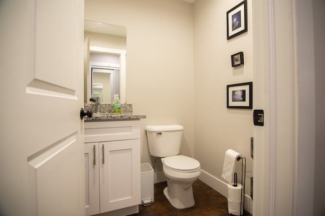 1226 E Bernhard Ave, Hazel Park, MI 48030 - bathroom with baseboards, toilet, wood finished floors, and vanity