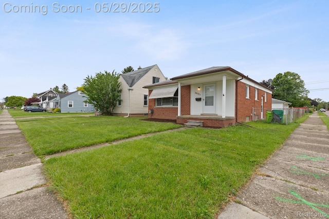 24371 Grove Ave, Eastpointe, MI 48021 - view of front of home featuring brick siding, a front yard, and board and batten siding