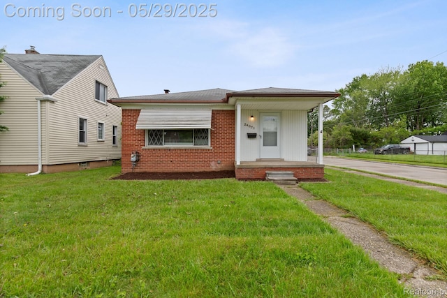 24371 Grove Ave, Eastpointe, MI 48021 - view of front facade featuring a front lawn, brick siding, and concrete driveway