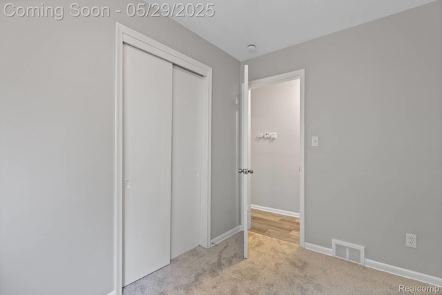 24371 Grove Ave, Eastpointe, MI 48021 - unfurnished bedroom with light carpet, a closet, and baseboards