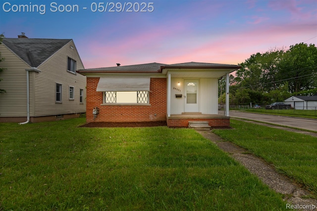 24371 Grove Ave, Eastpointe, MI 48021 - view of front of property with a front yard, brick siding, and concrete driveway